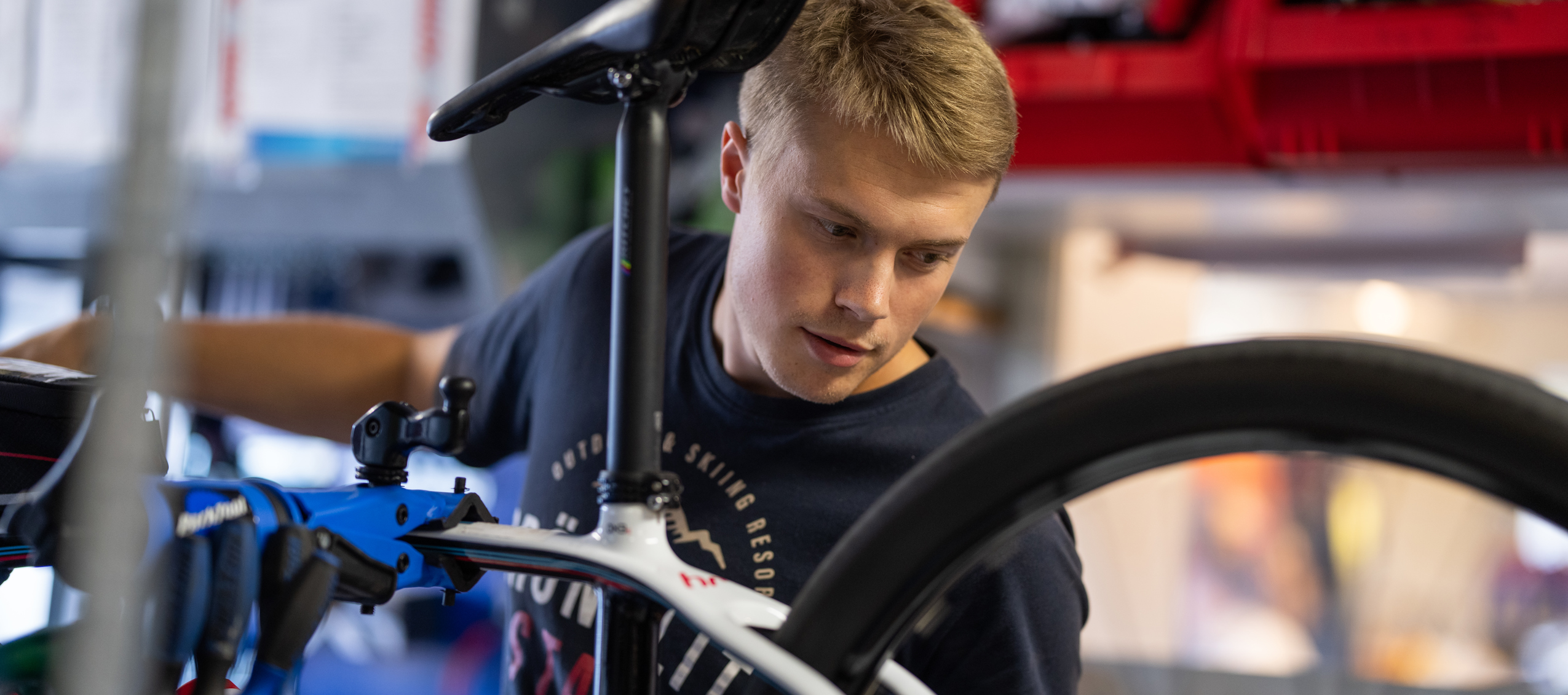 Person repairing a bicycle in a workshop